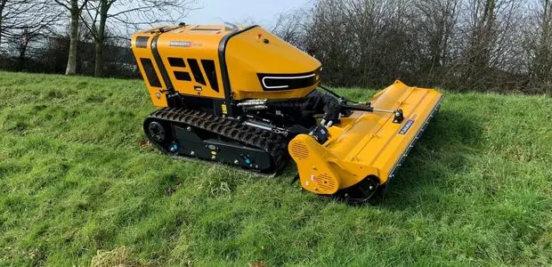 Remote-controlled tracked flail mower cutting a steep bank